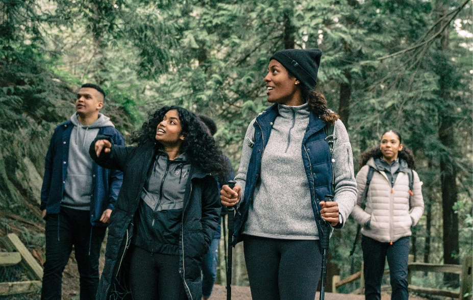 A group of people walking in the woods.
